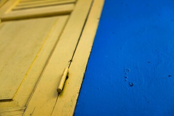 Low angle shot of a metallic door painted yellow and blue