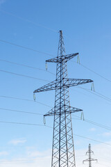 Metal pole of an overhead power line vertically against the sky.