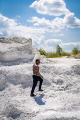 Shirtless healthy male person outside. Young muscular man standing outdoor.