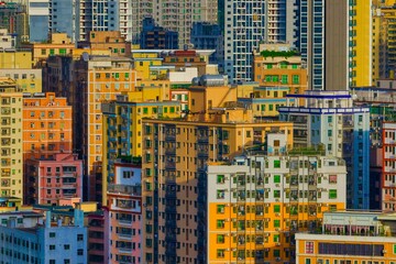 Exterior view of colorful residential buildings in a city on a bright, sunny day