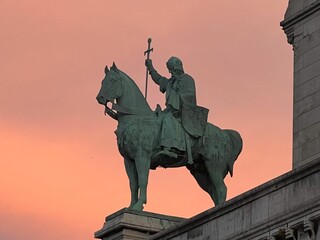 Statue of the Coeur Basilica in Paris at sunset