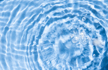 Water Surface Background. Circle sun reflections in pool water from above.