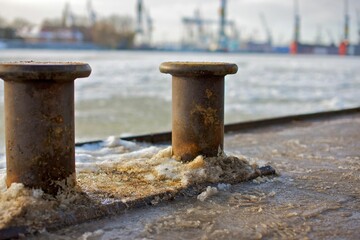 Closeup of metal poles in port