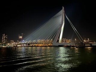 Fototapeta na wymiar Beautiful shot of the illuminated Erasmus Bridge in Rotterdam at night