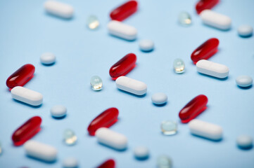 Macro shot medical pills, translucent dragees and gelatin capsules fith fat-solubles vitamins and...
