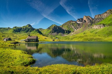 Aerial view of lake surrounded by greenery mountains