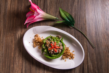 wok fried chinese French bean with minced pork and pickle turnip chilli mini shrimp in superior wolf berry stock sauce on wood table asian chinese vegan healthy halal food banquet restaurant menu