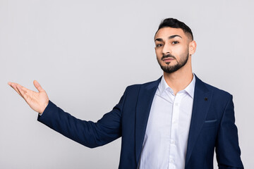 Turkish young handsome man guy wearing stylish smart ellegant suit costume and white shirt buisnessman over grey background in studio isolated.