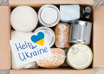 products in a cardboard box with the inscription Help for Ukraine, top view