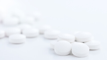 White tablets scattered on the pharmaceutical table