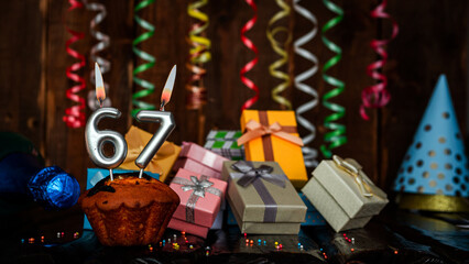 Birthday background with muffin and candles with number  67. Beautiful anniversary background with...