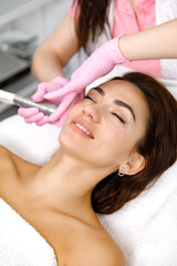 Obraz na płótnie Canvas Skin care service,Rejuvenating facials,Hydro-microdermabrasion,esthetic procedure. woman is having a beauty treatment at the cosmetologist's office