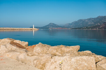 Small lighthouse in mediterranean sea in Montenegro, focused on stone