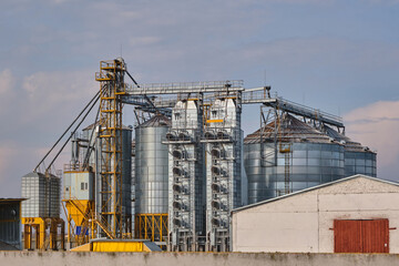 Fototapeta na wymiar agro-processing plant for processing and silos for drying cleaning and storage of agricultural products, flour, cereals and grain