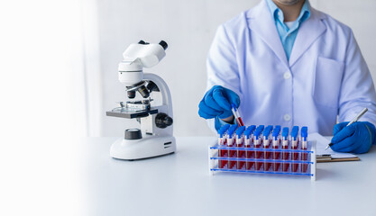 Medical researcher and blue latex gloves to prevent germs Shows a patient's blood vessels being...