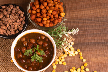 Chole masala or chana indian vegan food made of cooked chickpeas, tomatoes and cumin decorated with...