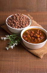 Chole masala or chana indian vegan food made of cooked chickpeas, tomatoes and cumin decorated with onion rings.