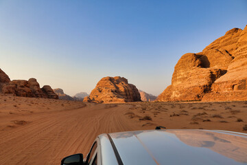 landscape view at sunset of wadi rum desert from offroad vehicle