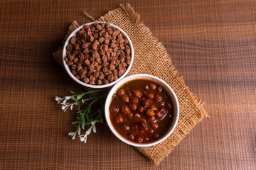 Chole masala or chana indian vegan food made of cooked chickpeas, tomatoes and cumin decorated with onion rings.