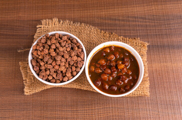 Chole masala or chana indian vegan food made of cooked chickpeas, tomatoes and cumin decorated with onion rings.