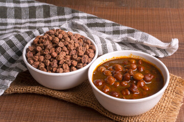 Chole masala or chana indian vegan food made of cooked chickpeas, tomatoes and cumin decorated with onion rings.