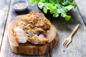 fried pork on wooden chopping board