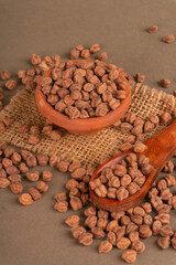Black Chickpeas or Kala Chana with chana dal pulse isolated on wooden Background.