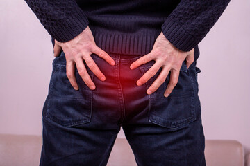Man with diarrhea problem, man with digestive problem touching his buttock, man with hemorrhoid...