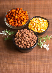 Black Chickpeas or Kala Chana with chana dal pulse isolated on wooden Background.
