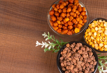 Black Chickpeas or Kala Chana with chana dal pulse isolated on wooden Background.