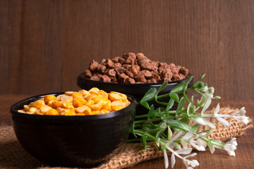 Black Chickpeas or Kala Chana with chana dal pulse isolated on wooden Background.