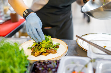 Chef cooking salad with fresh vegetables on restaurant kitchen