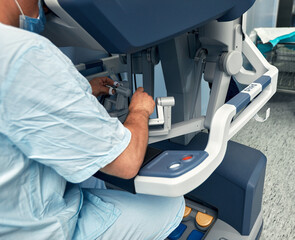 Hands of a surgeon at a computer robot. medical robot. Robotic Surgery.