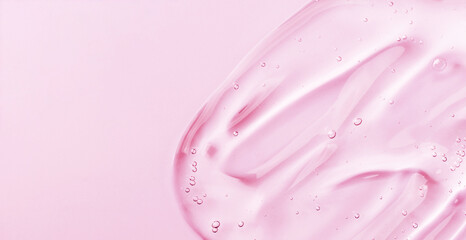 Serum gel smear on pink background. Cosmetic transparent gel serum texture.