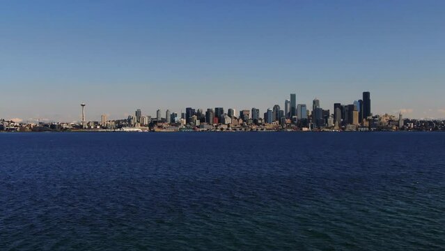Flying above Hamilton Viewpoint Park Elliot Bay water aerial towards downtown Seattle city pan up needle eye blue sky and sunny
