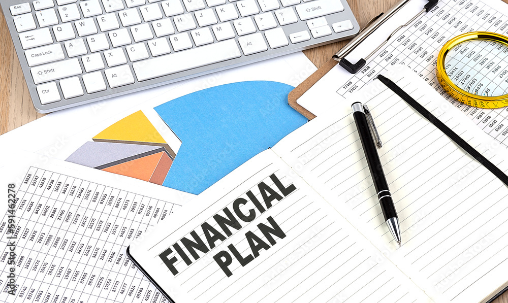 Poster financial plan text on notebook with chart and keyboard