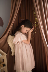 Beautiful young girl wearing angel wings