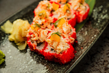 A close-up of set of sushi served on a plate with garnish