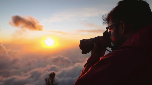 photographer capturing volcano above the clouds in guatemala sunrise