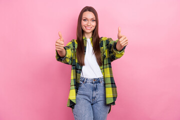 Photo of gorgeous cheerful woman with long hairstyle wear checkered shirt showing thumbs up good job isolated on pink color background