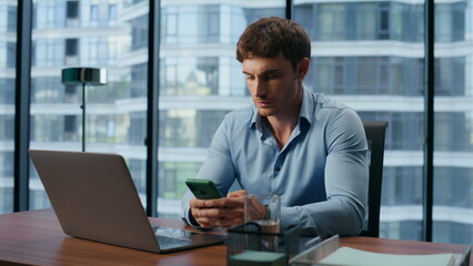 Fototapeta na wymiar Thoughtful businessman reading phone news closeup. Man looking mobile screen