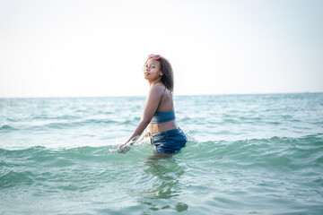 Portrait of black beautiful teenage girl having fun on sea beach,Summer vacation,Sunny hot summer day at tropical ocean beach.