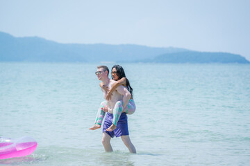 Happy couple together on sea beach,Travel and beach fun and summer vacation or honeymoon.
