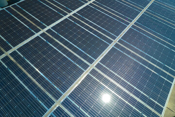 Aerial view of solar panels installed as shade roof over parking lot for parked cars for effective...