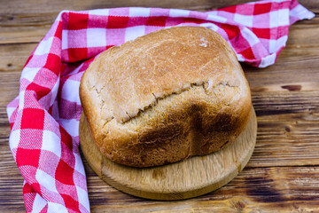 Loaf of freshly baked bread on a wooden table