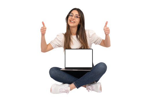Transparent png image of cheerful woman sitting on the ground with the computer on her lap recommending website. Showing thumb up with two hands. Smiling to camera. White blank screen laptop mock up.