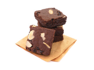 Brownies on paper isolated white background. Chocolate brownie with sliced almond nuts toppings. Chocolate Brownie pieces. selective focus.