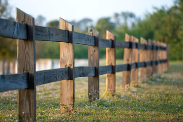 Wooden fence barrier at farm grounds for cattle and territory protection
