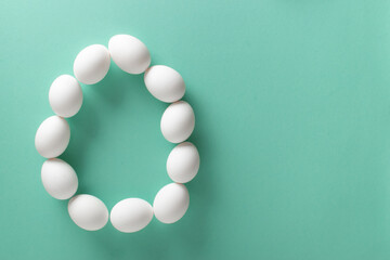 Banner with the image of a large egg made of white eggs on a light blue background. Space for text. Minimalism.