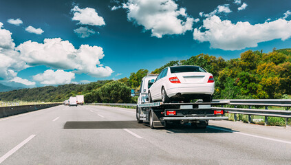Tow Truck Transporting Car Or Help On Road Transports Wrecker Broken Car. Car Service Transportation Concept. Auto Towing, Tow Truck For Transportation Faults And Emergency Cars . Tow Truck Moving In - 591477280